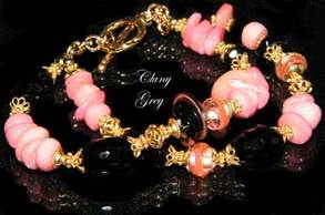 genuine coral bracelet with lampwork, onyx, and gold