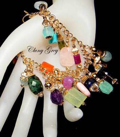 Charm bracelet with gems and gold.