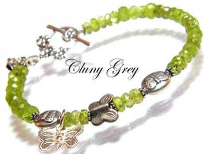 Peridot bracelet with sterling silver and a butterfly charm.