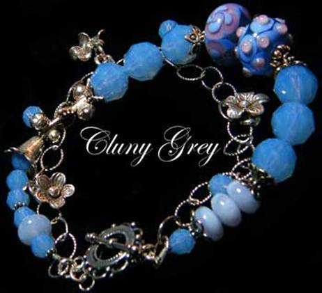 Swarovski crystals bracelet with air blue opal and sterling silver flower charms.