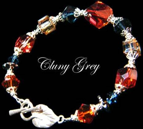  Sterling silver Swarovski crystal bracelet with red, blue and gold beads.