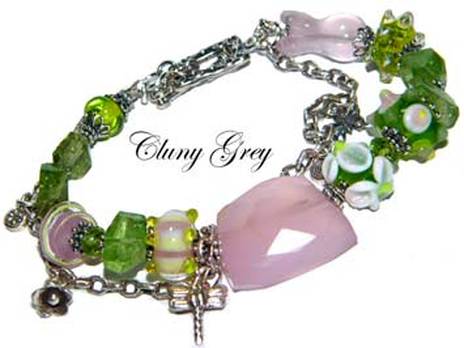 Peridot bracelet of two strands with lamp worked beads, rose quartz and charm.