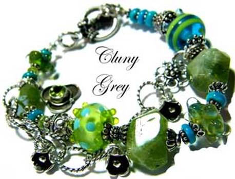 Peridot bracelet with two-tone lamp worked beads, sterling silver and charm.
