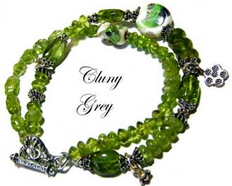 Peridot bracelet of two strands, lamp worked beads, sterling silver and carved ovals.